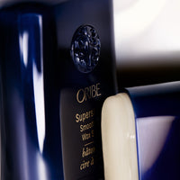 Close-up of an open Oribe Supershine Smoothing Wax Stick
