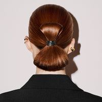 Model with a sleek low bun