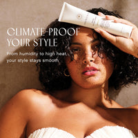 Model with curly hair holding Innersense Air Dry Styling Cream