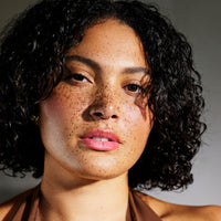 Model with short curly hair, Innersense Air Dry Styling Cream