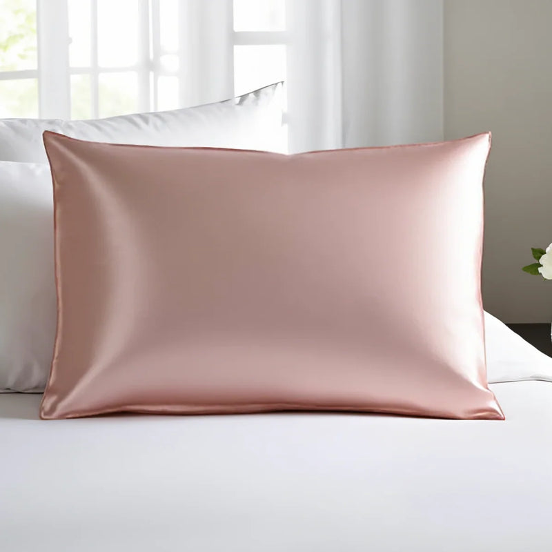 Esmé silk pillowcase in pink on a bed