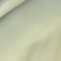 Close-up video of a styling cream texture being spread with a spatula