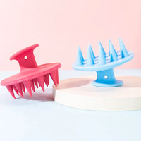 Shop Curls scalp massagers in pink and blue
