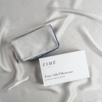 Esmé 100% Pure Silk Pillowcase folded beside its Esmé packaging