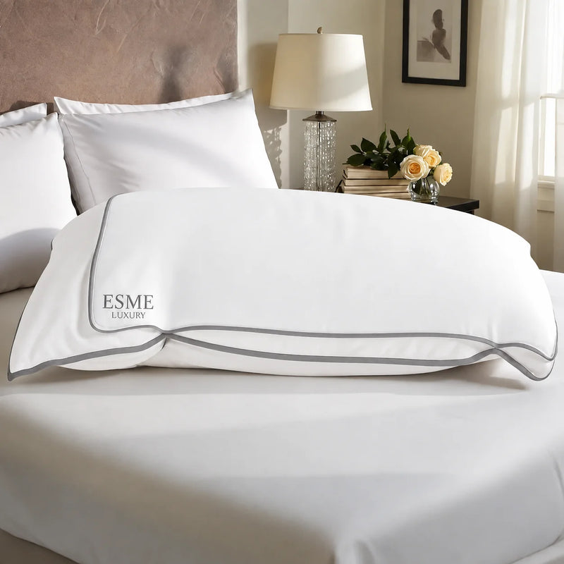 Esmé travel slip pillowcase in white on a bed